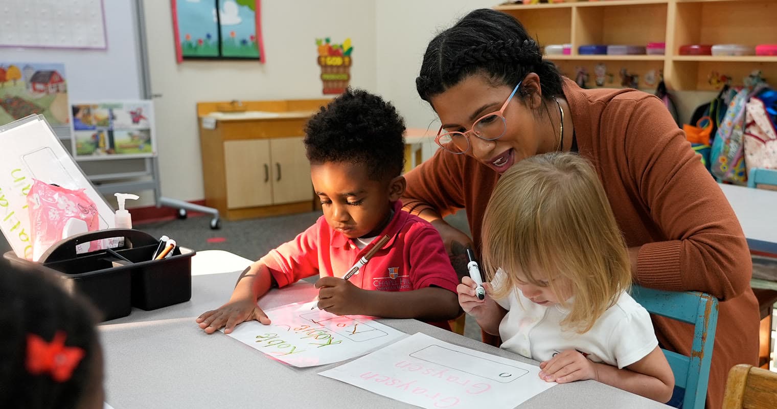 A teacher helping students at Chapel Hill Christian School